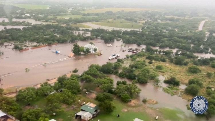 A family surveys flood damage in their San Antonio home.