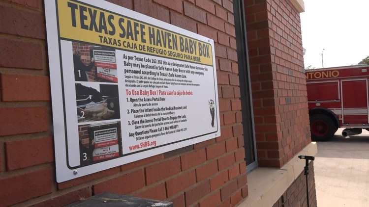 San Antonio Fire Department members and child advocates gather around a newly installed Safe Haven Baby Box.
